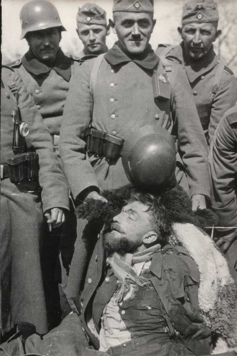 Grisly Ending. Soldiers of Nazi Germany proudly display their ‘prized trophy’ - the captured, killed and bloodied Commanding officer of Romuald’s unit, Major Henryk ‘Hubal’ Dobrzanski.