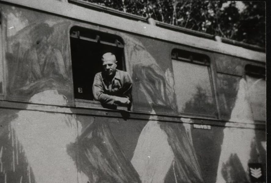 Following his liberation from the notorious Auschwitz Nazi death camp, Roman is transported to safety aboard an Allied Forces camouflaged train carriage during 1945.