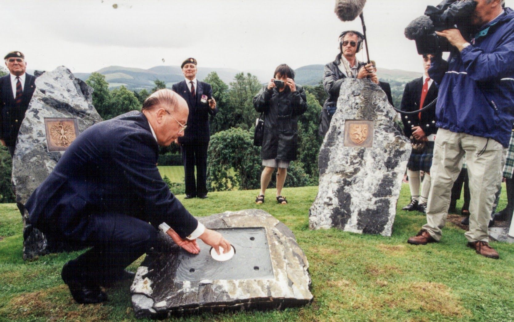 Incumbent Scottish Borders Convener Drew Tully interns a time capsule within the centrepiece National Polish memorial.