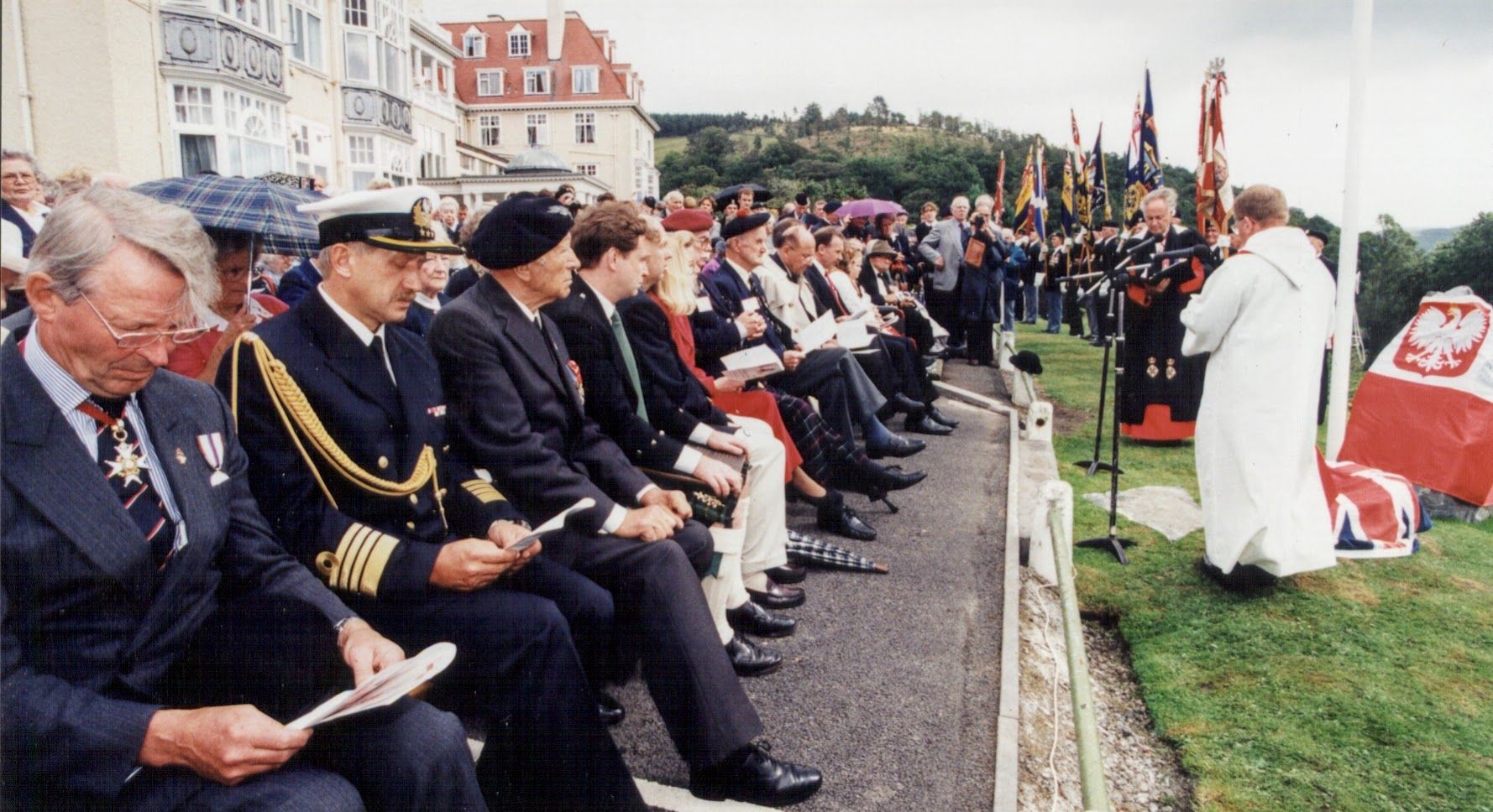 A packed gallery of the great and good looking on as ceremonial unveiling and dedication proceedings of the Polish memorial take place.