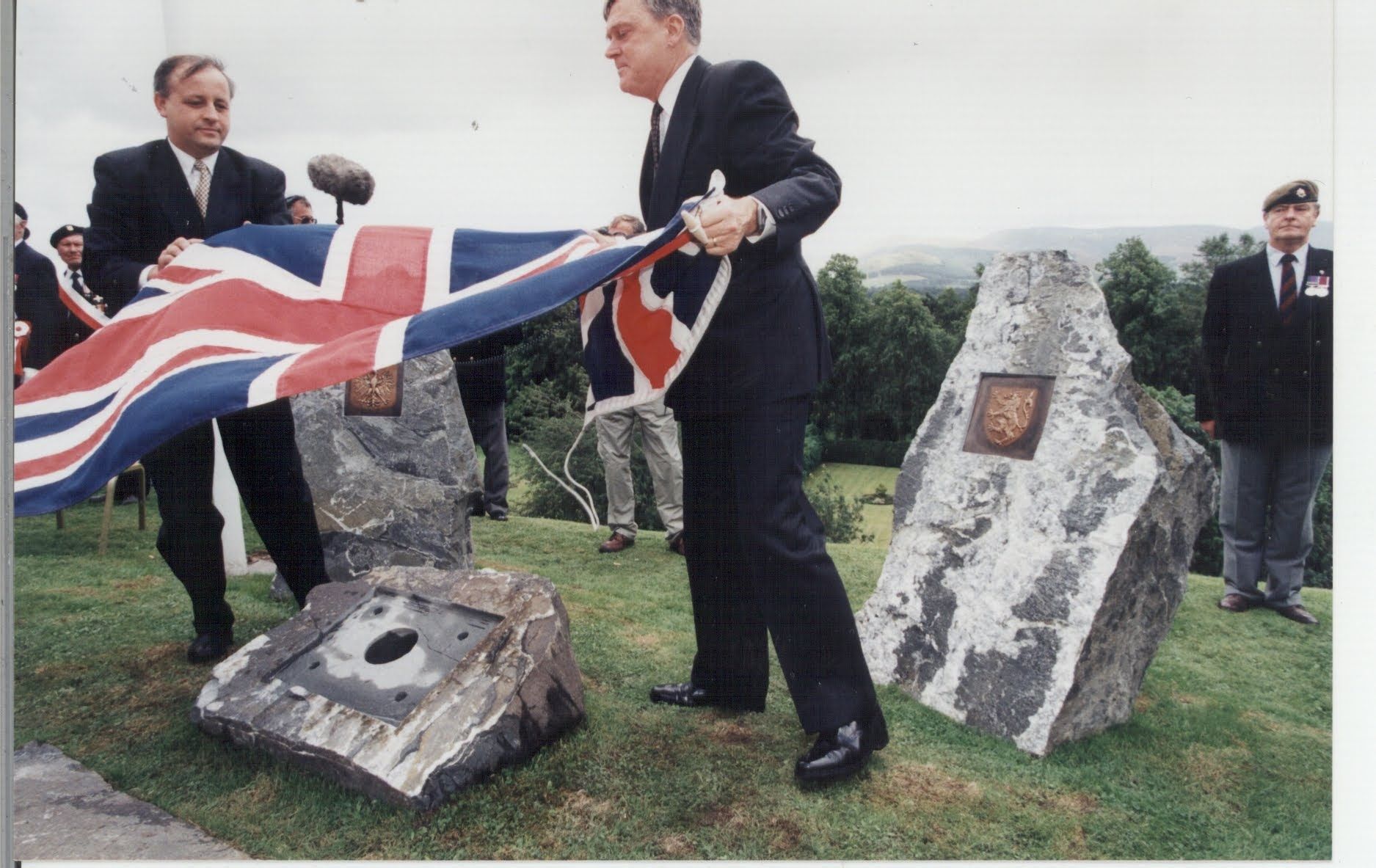 Peebles incumbent Hydropathic Hotel Director and General Manager Pieter Van Dijk (right), together with Scotland's Polish Consular General, lift a British Union Jack flag from the centrepiece memorial stone in preparation for a time capsule internment, and bronze plaque installation.